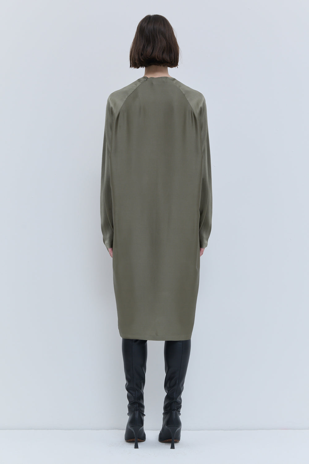 Elegant artichoke batwing sleeve dress with fluid silhouette and detachable scarf.