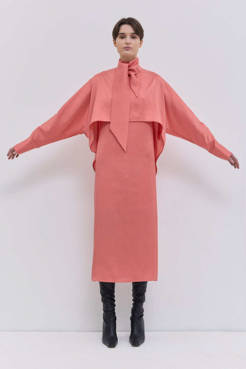 Luxury coral midi dress showcasing the natural texture and irregular beauty of tussah silk