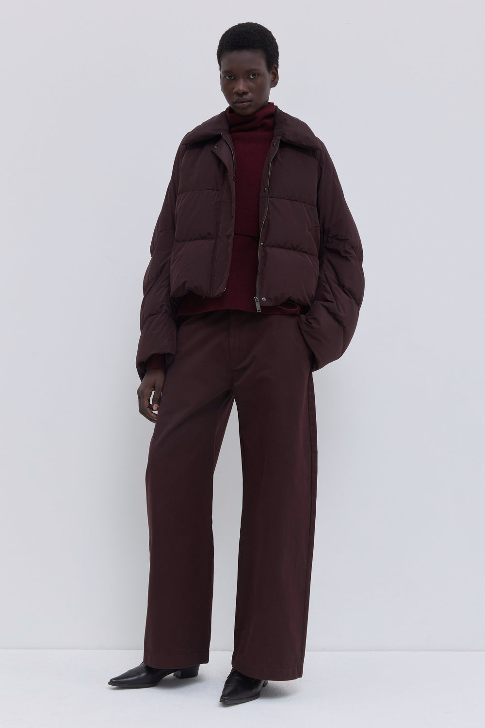 Front view of the Jani oversized down jacket with statement collar in plum.