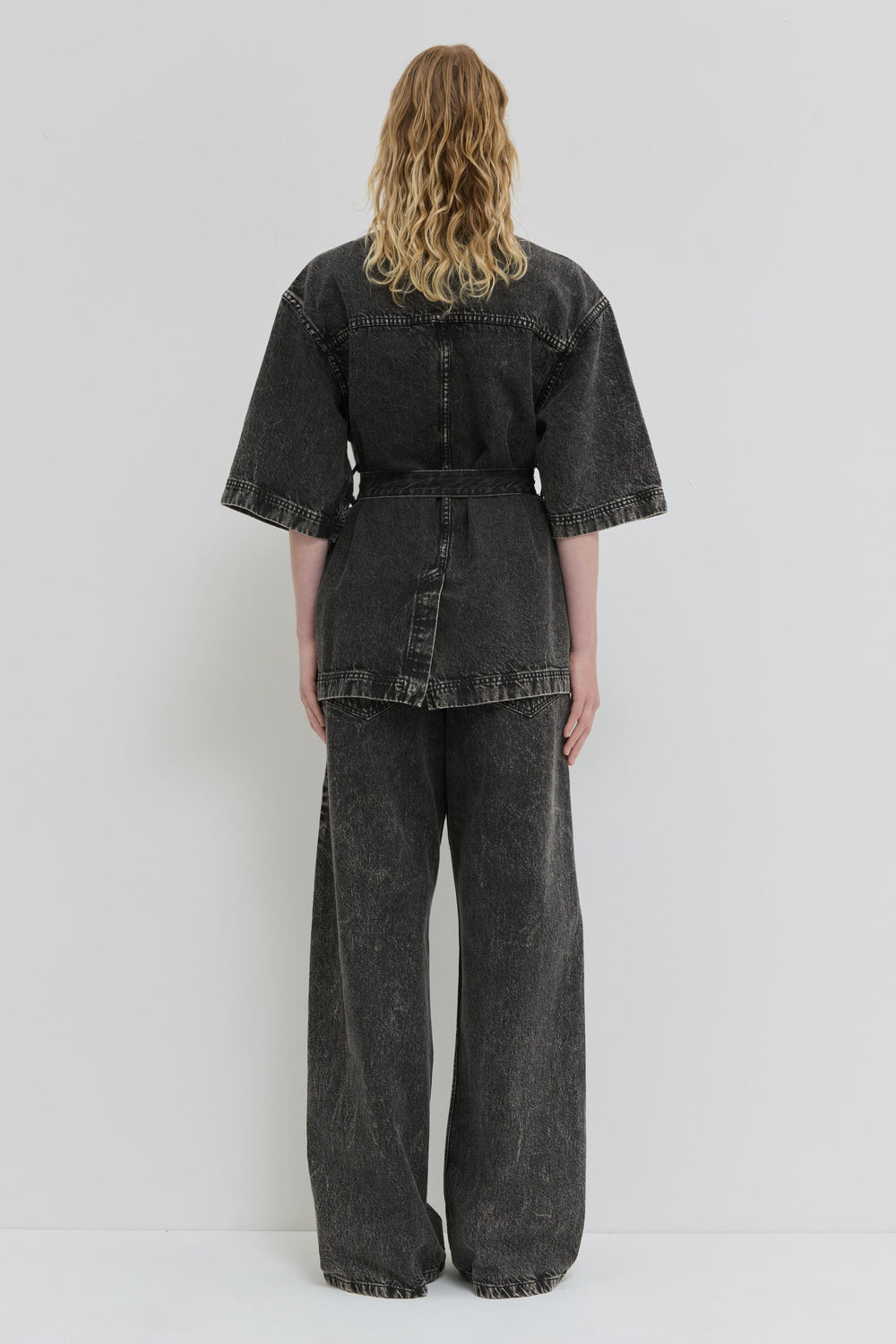 Dark denim jacket with short kimono sleeves and belt detail back view