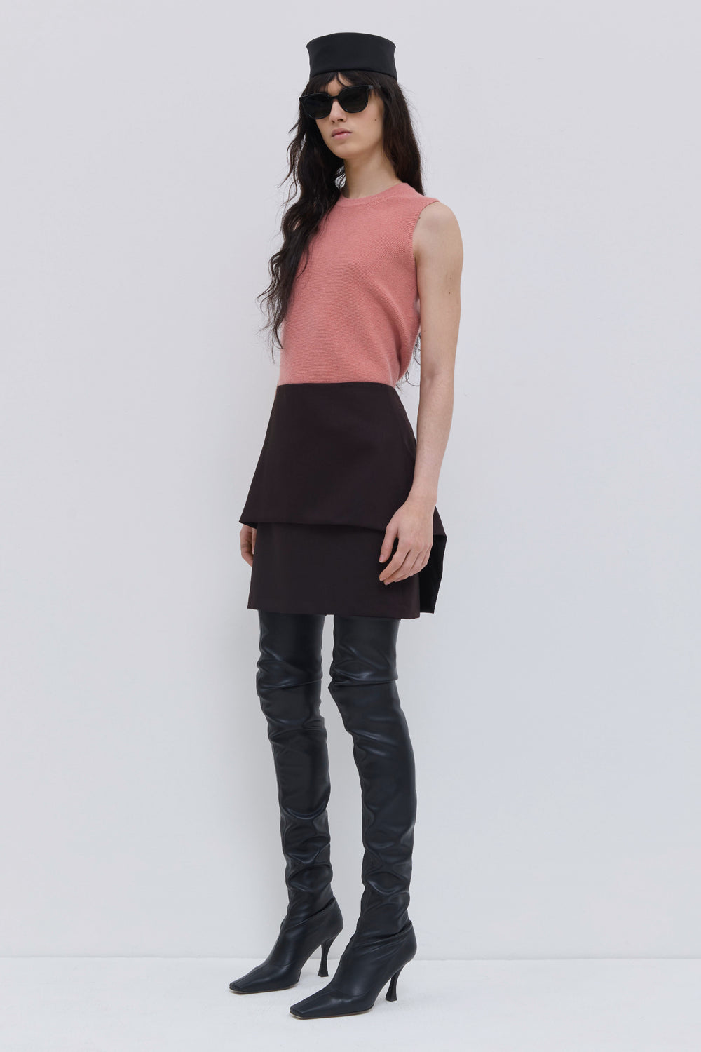 Front view of a coral seamless sleeveless knit top with a relaxed fit.