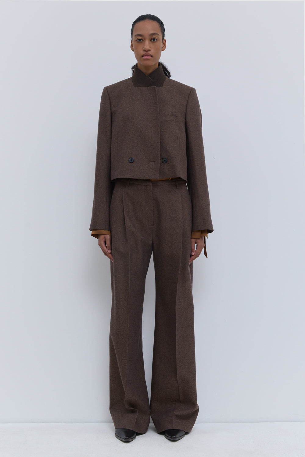 Christian Wijnants Pamira rust tweed wide-leg trousers with front pleat, styled in a full-length front view.