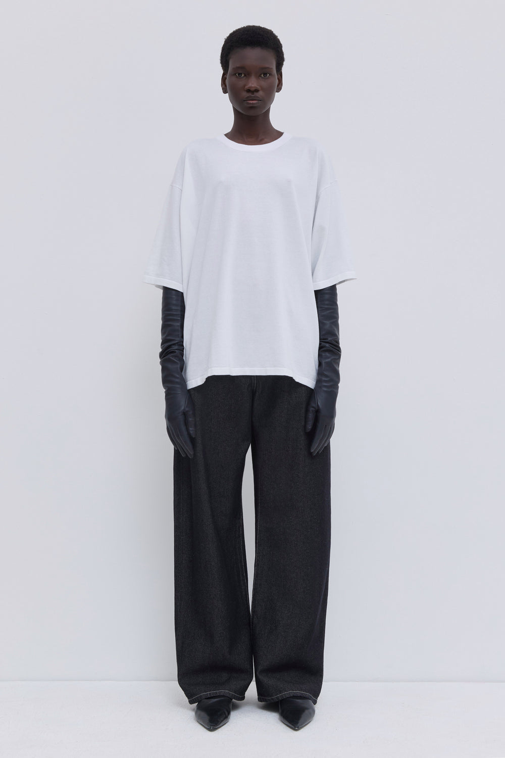 High-rise dark raw denim jeans with a relaxed full-length silhouette.