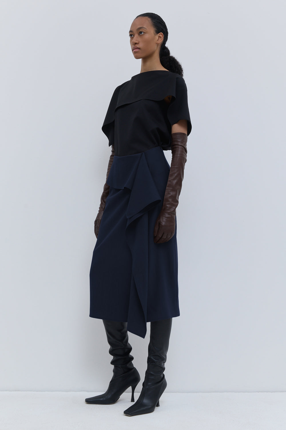 Christian Wijnants Sailo dark navy skirt with layered draped panel, front view.