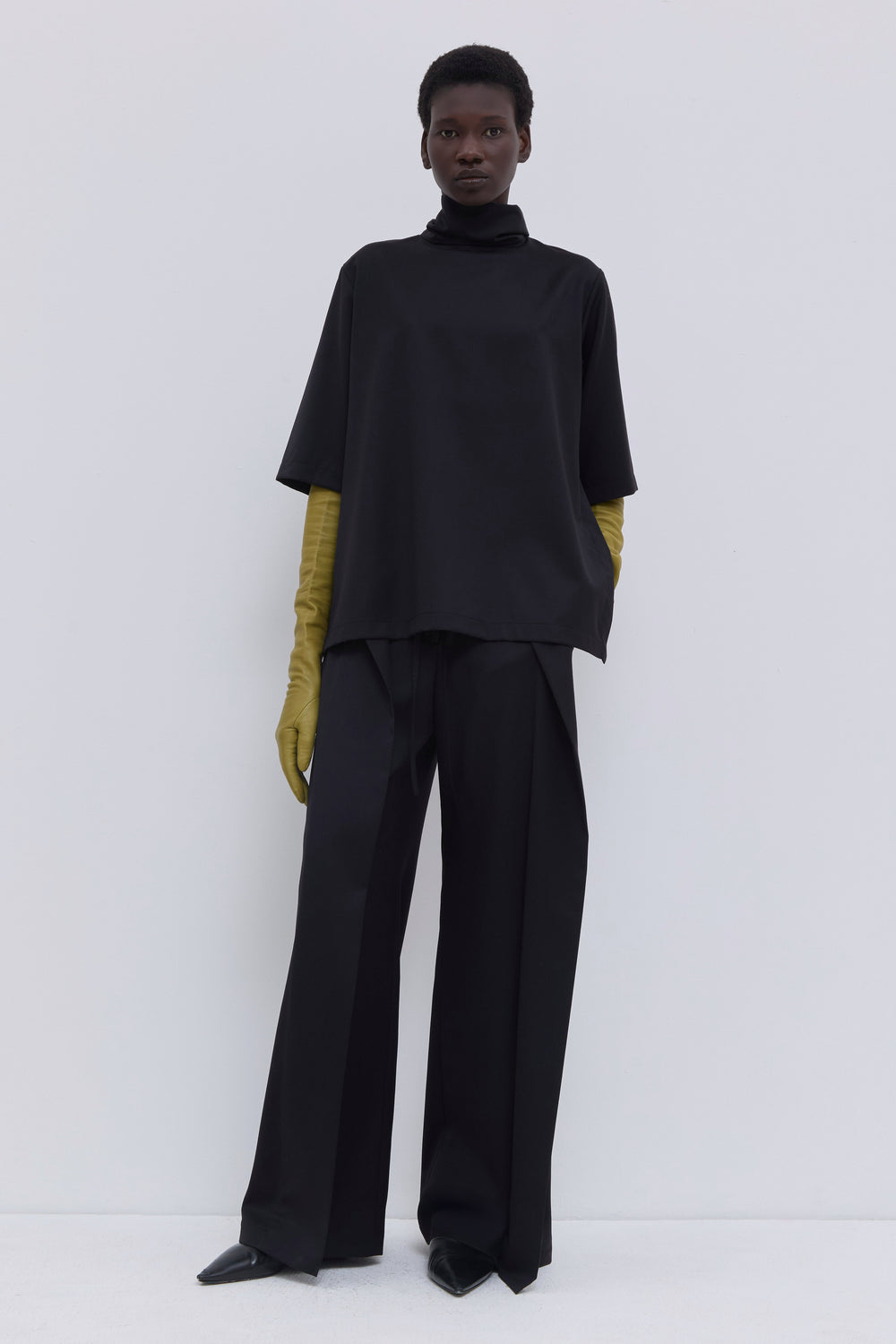 Relaxed black wool top with loose scarf detail