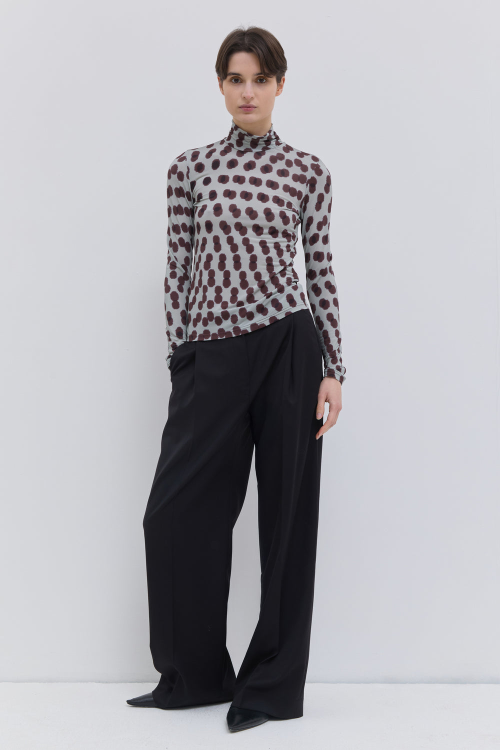 Front view of the Tugal turtleneck top in plum polka print stretch jersey.